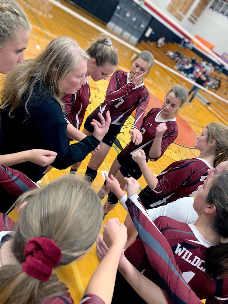 Volleball Coach, Barbara Rasmus, in a huddle with her team